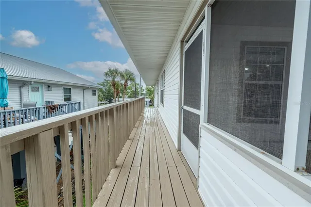 a view of balcony with wooden floor