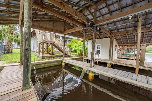 a view of a large room with wooden floor and iron stairs