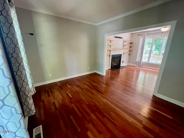 wooden floor in an empty room with a fireplace
