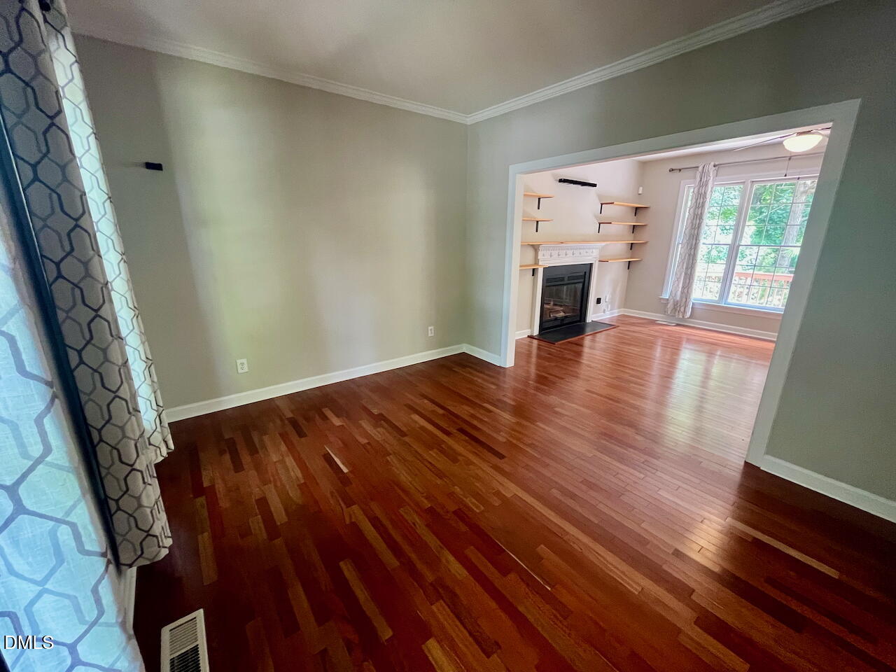 8528 Yucca Trail Raleigh, NC 27615 - Photo 12 of 25 wooden floor in an empty room with a fireplace