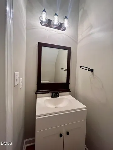 a bathroom with a sink a mirror and vanity