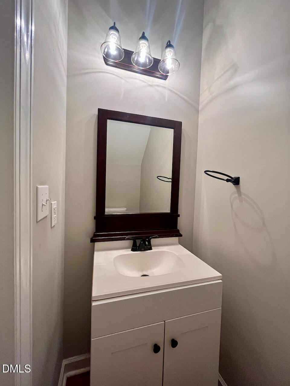 8528 Yucca Trail Raleigh, NC 27615 - Photo 13 of 25 a bathroom with a sink a mirror and vanity