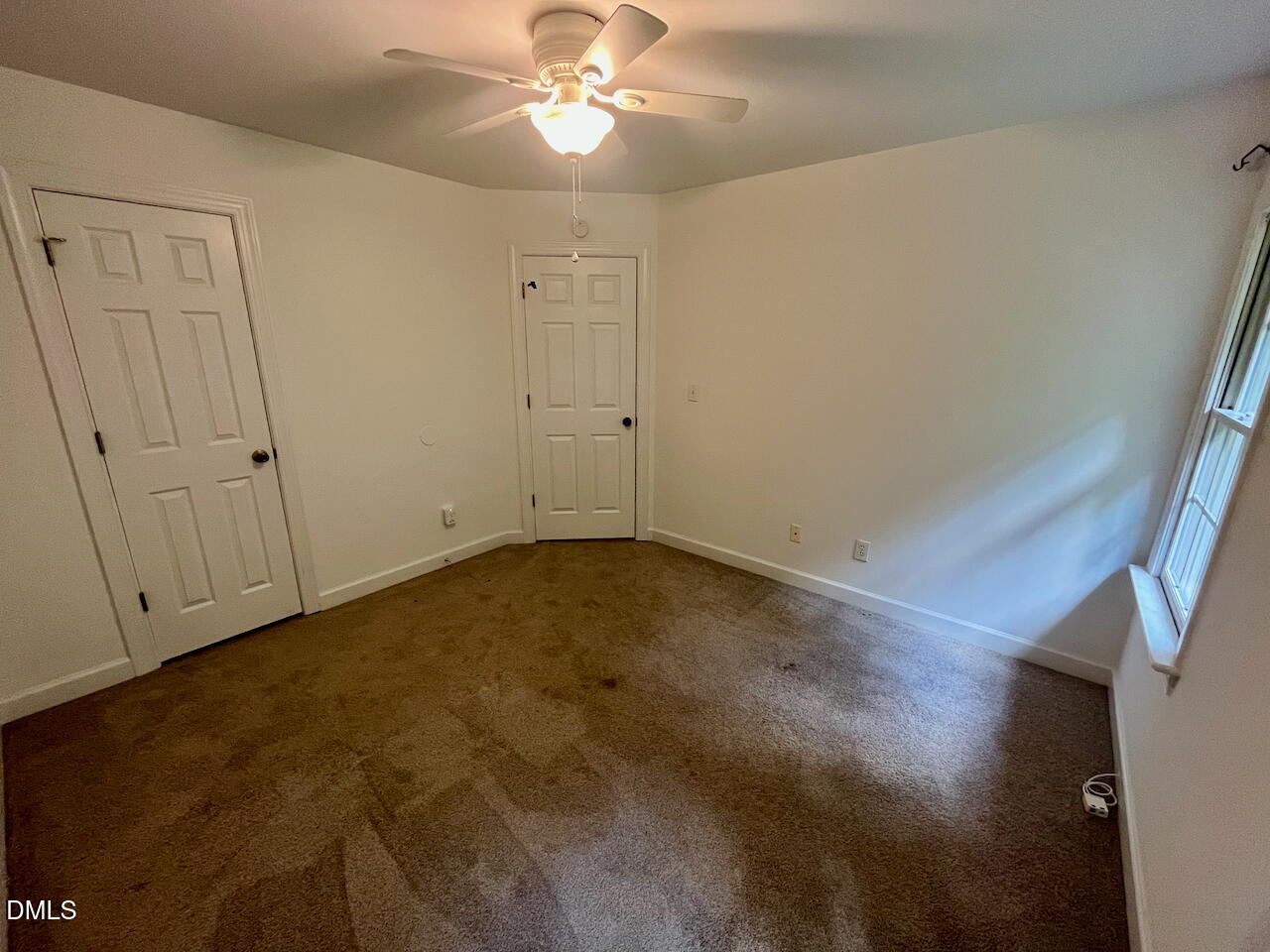 8528 Yucca Trail Raleigh, NC 27615 - Photo 19 of 25 an empty room with a chandelier fan