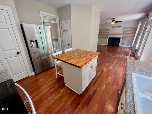 a hallway with table and wooden floor