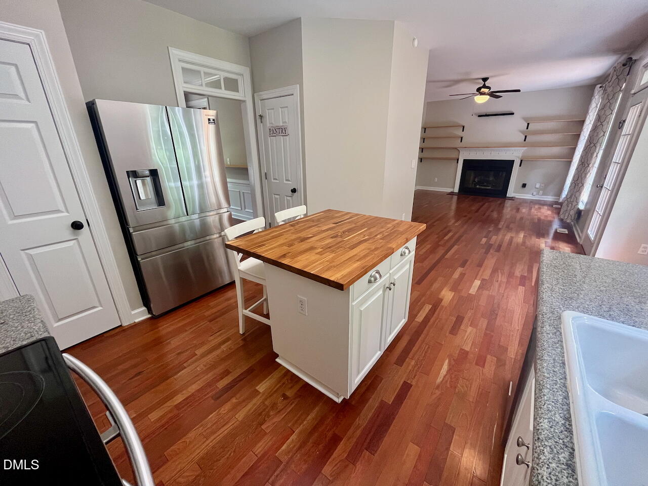 8528 Yucca Trail Raleigh, NC 27615 - Photo 6 of 25 a hallway with table and wooden floor