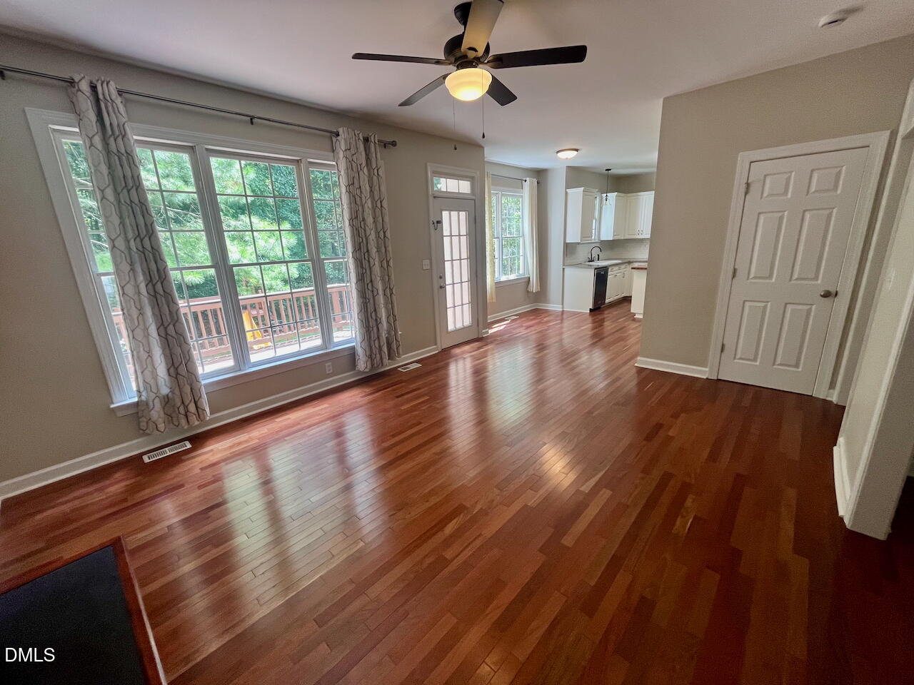 8528 Yucca Trail Raleigh, NC 27615 - Photo 10 of 25 a view of an empty room with window and wooden floor