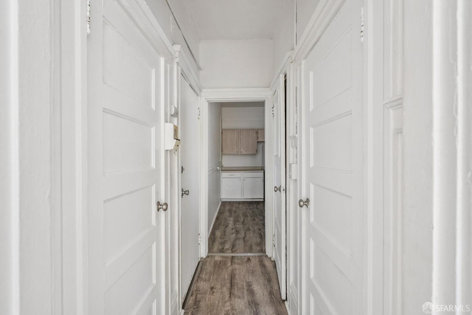 669 Ellis Street San Francisco, CA 94109 - Photo 14 of 32 a view of a hallway with wooden floor