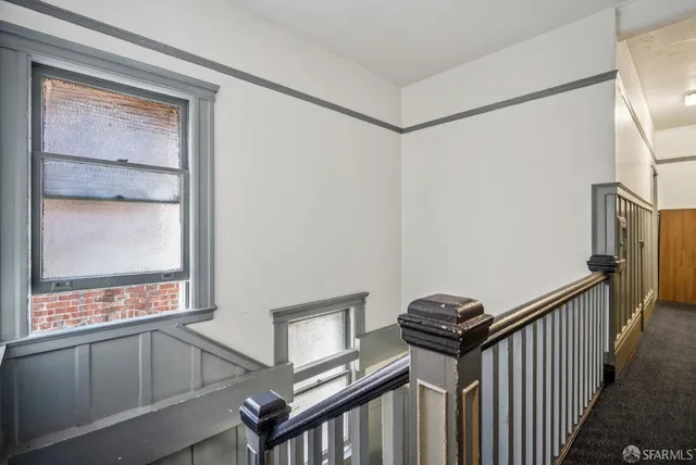 a view of a hallway with stairs