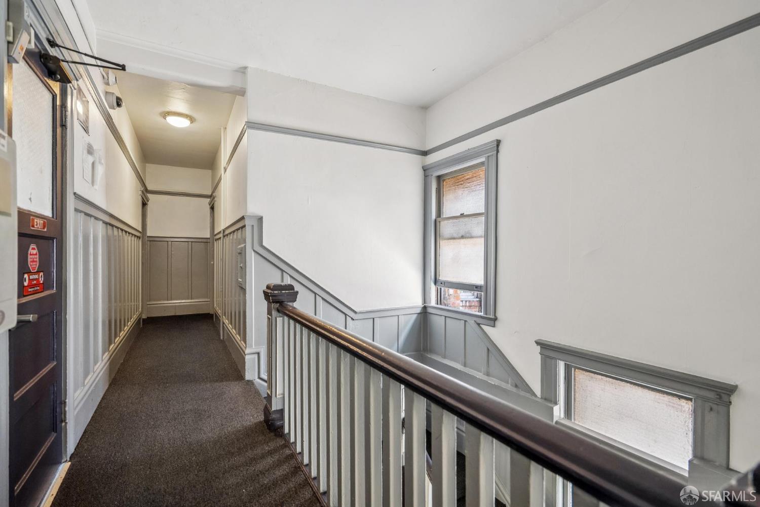 669 Ellis Street San Francisco, CA 94109 - Photo 19 of 32 a view of a hallway with wooden floor and staircase