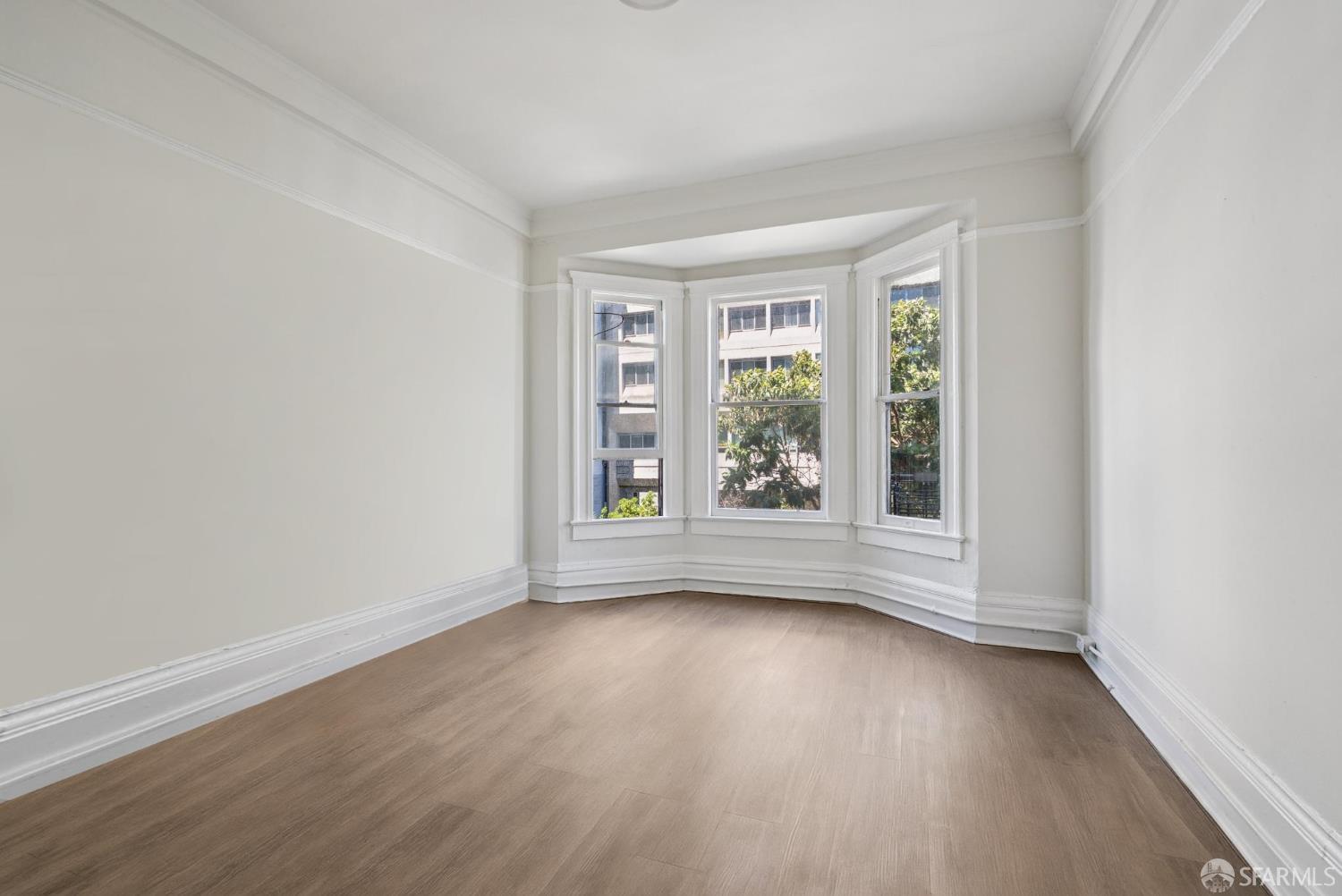 669 Ellis Street San Francisco, CA 94109 - Photo 21 of 32 an empty room with wooden floor and windows