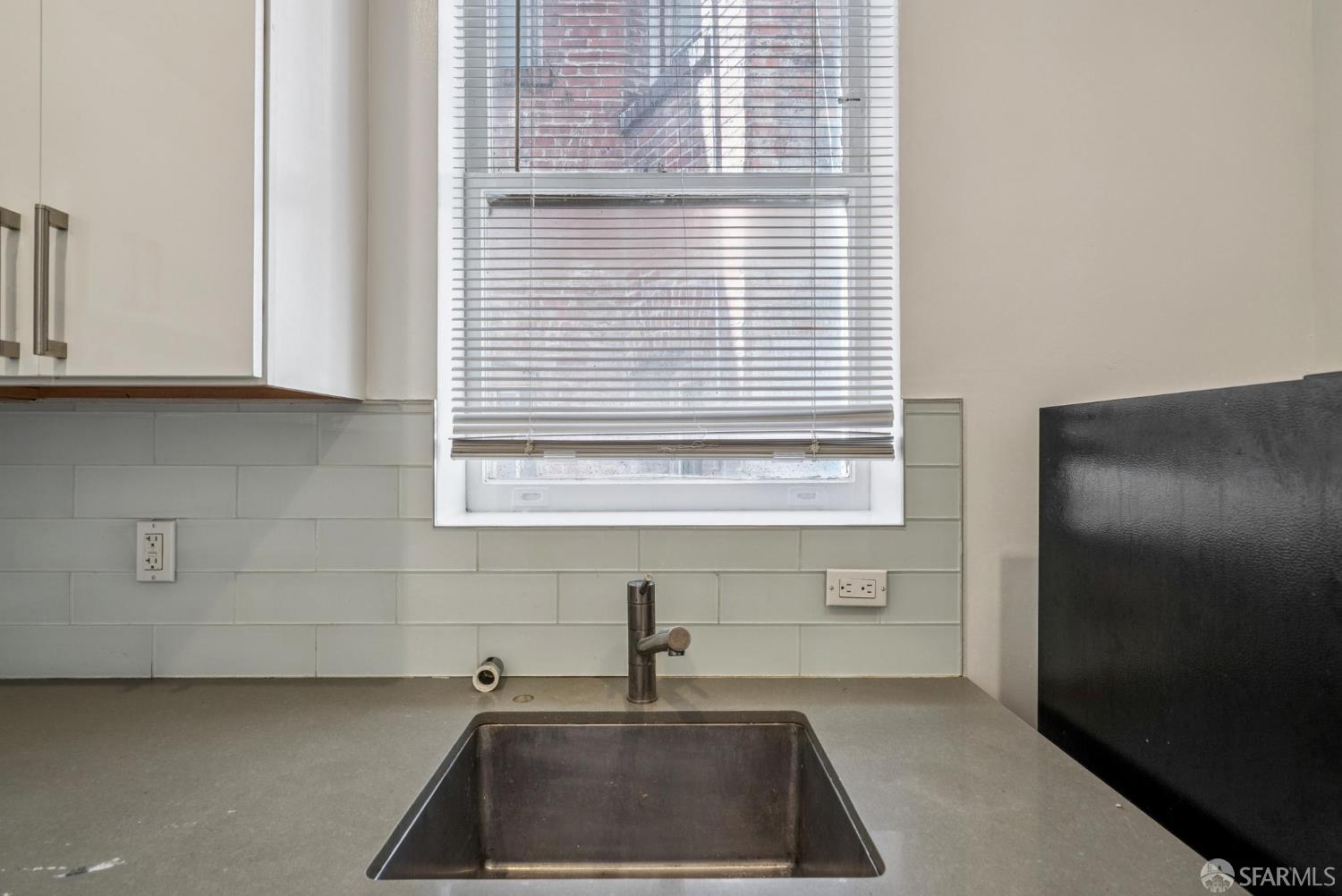 669 Ellis Street San Francisco, CA 94109 - Photo 26 of 32 a kitchen with a sink cabinets and a window