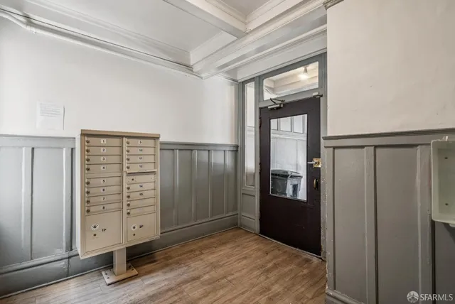 a view of an empty room with closet and windows
