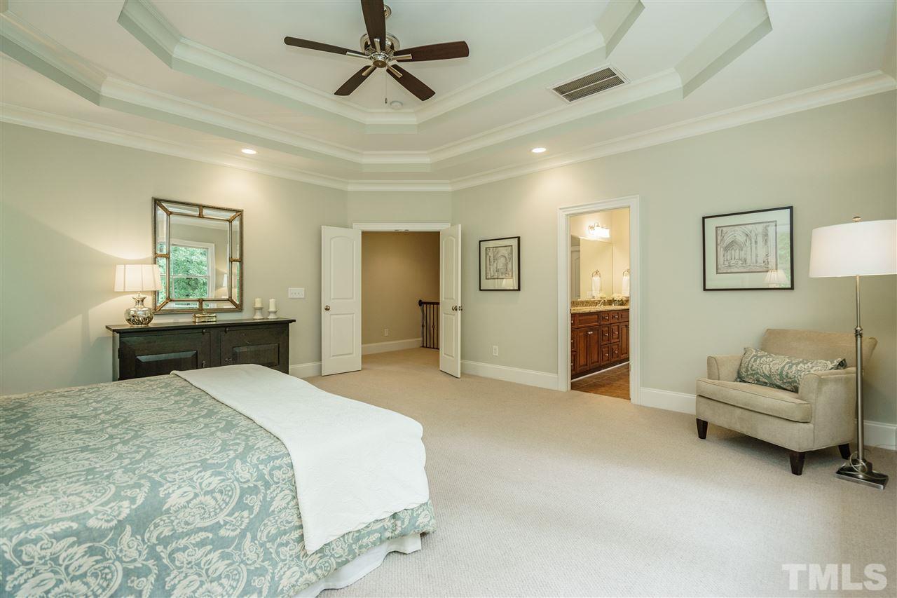 1801 Bowling Green Trail Raleigh, NC 27613 - Photo 13 of 25 a bedroom with a bed and ceiling fan
