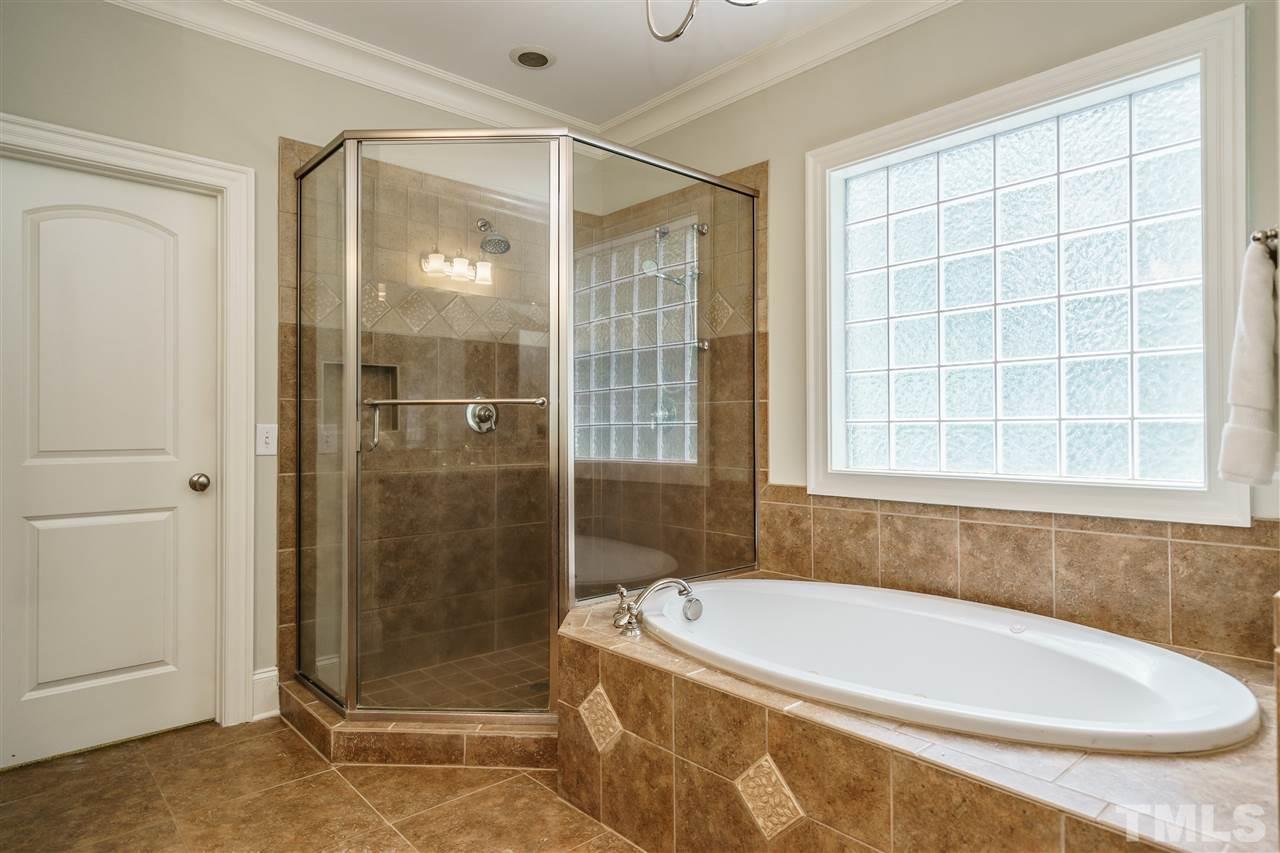 1801 Bowling Green Trail Raleigh, NC 27613 - Photo 15 of 25 a bathroom with a tub and shower