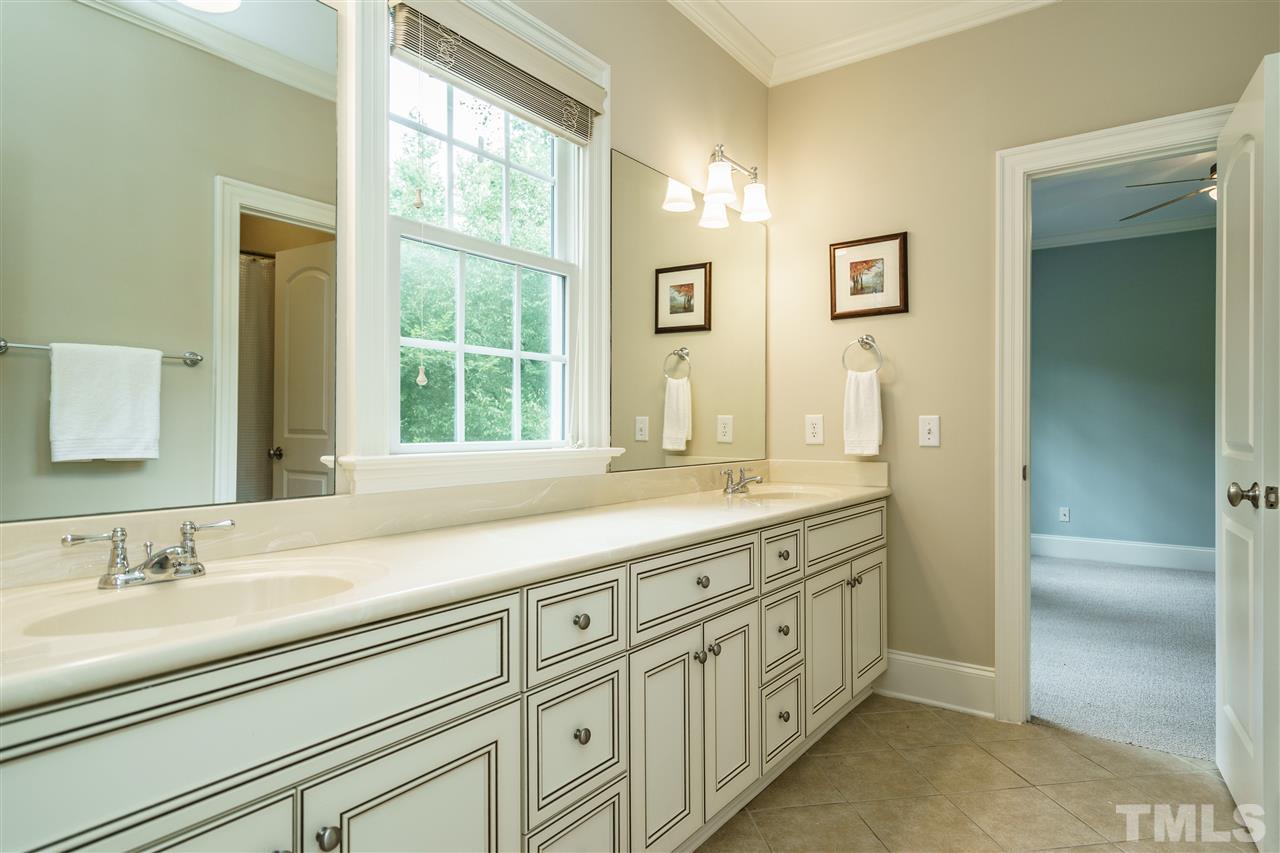 1801 Bowling Green Trail Raleigh, NC 27613 - Photo 17 of 25 a bathroom with sinks double vanity and a tub