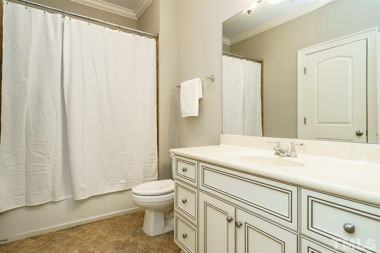 1801 Bowling Green Trail Raleigh, NC 27613 - Photo 20 of 25 a bathroom with a sink a toilet and shower