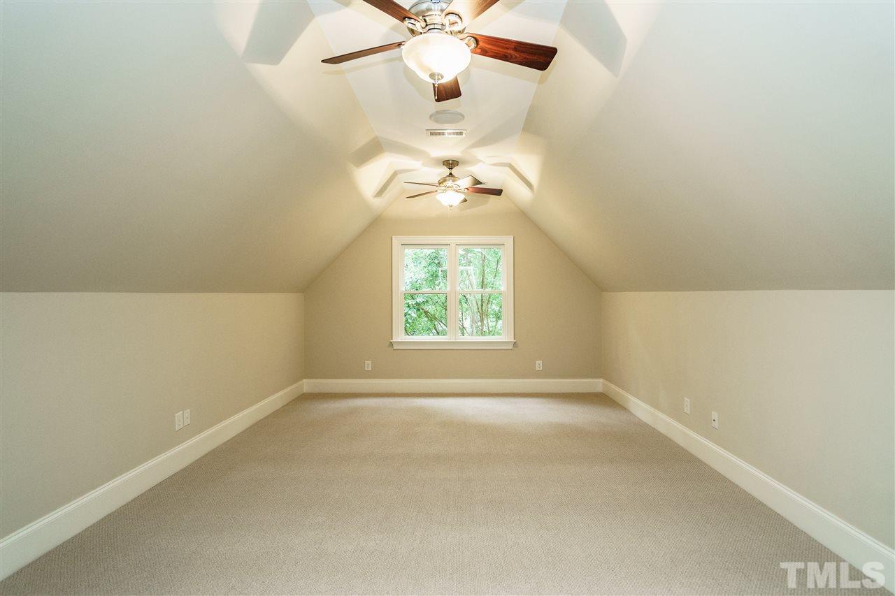 1801 Bowling Green Trail Raleigh, NC 27613 - Photo 21 of 25 an empty room with a window and a chandelier fan