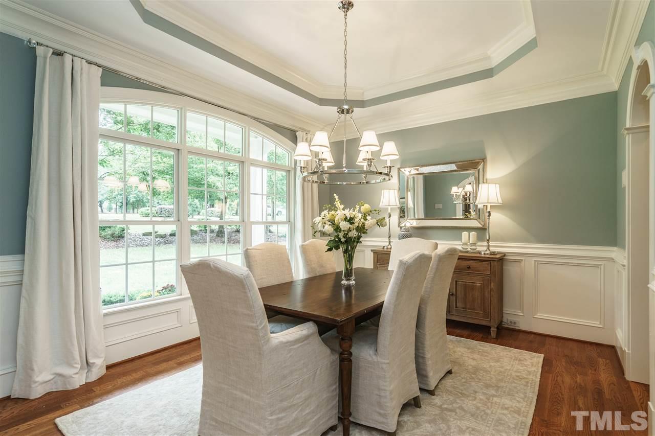 1801 Bowling Green Trail Raleigh, NC 27613 - Photo 5 of 25 a dining room with furniture a chandelier and wooden floor