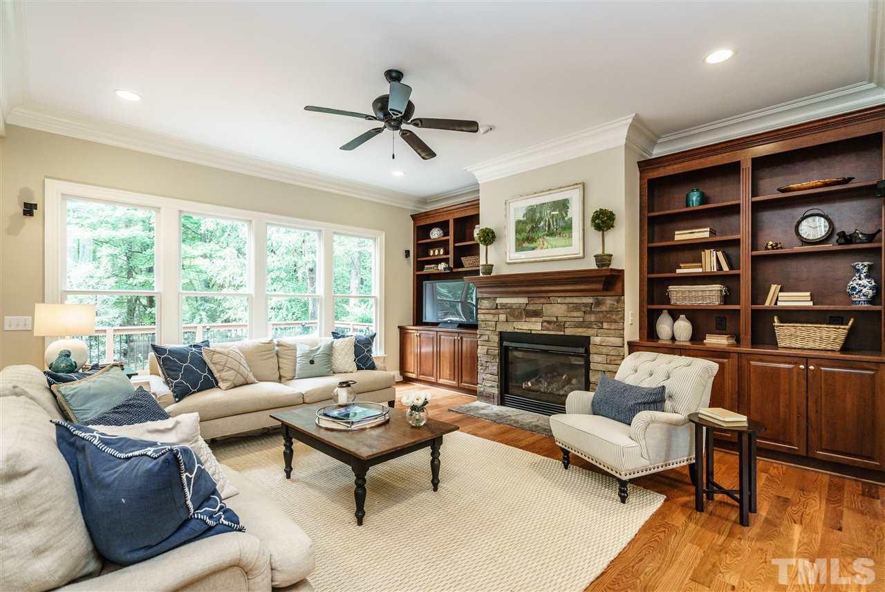 1801 Bowling Green Trail Raleigh, NC 27613 - Photo 6 of 25 a living room with furniture fireplace and a large window