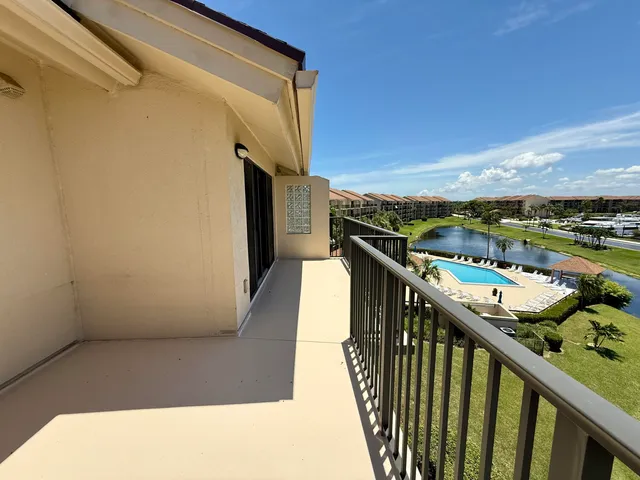 an aerial view of a house with a garden and lake view