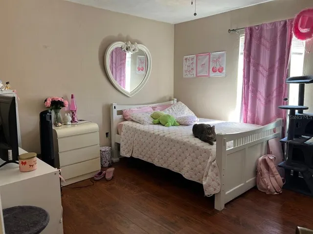 a bathroom with a granite countertop toilet sink and mirror