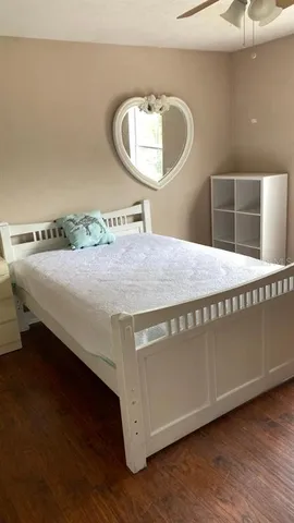 a bedroom with a bed and a mirror