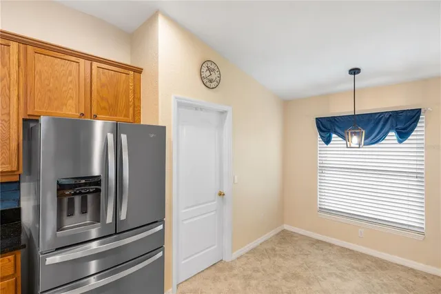a kitchen with stainless steel appliances granite countertop a refrigerator stove and sink