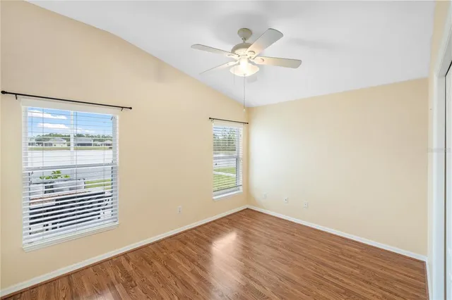 an empty room with wooden floor and a window