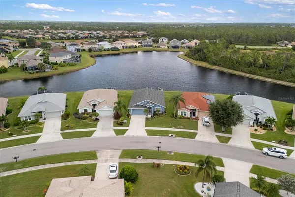 an aerial view of a house with a lake view