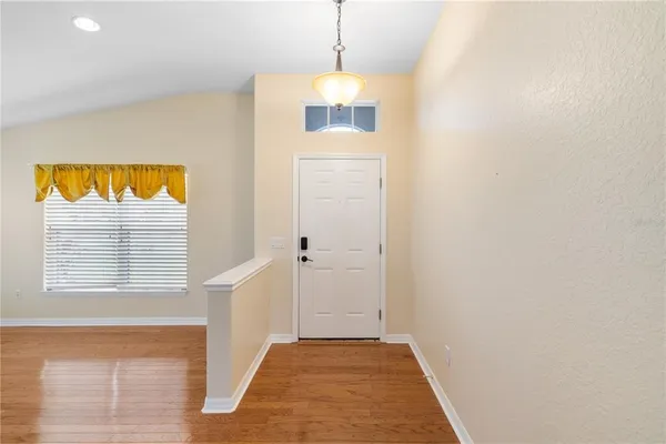 a view of a room with a chandeliers and a window