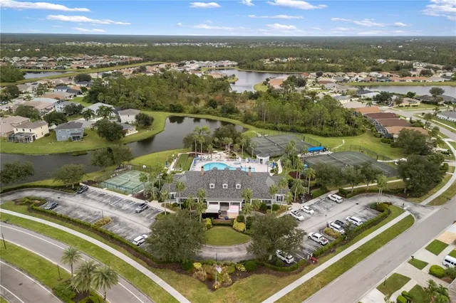 an aerial view of residential houses with outdoor space and parking