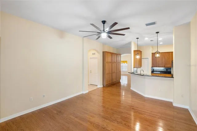 a view of an empty room with a kitchen