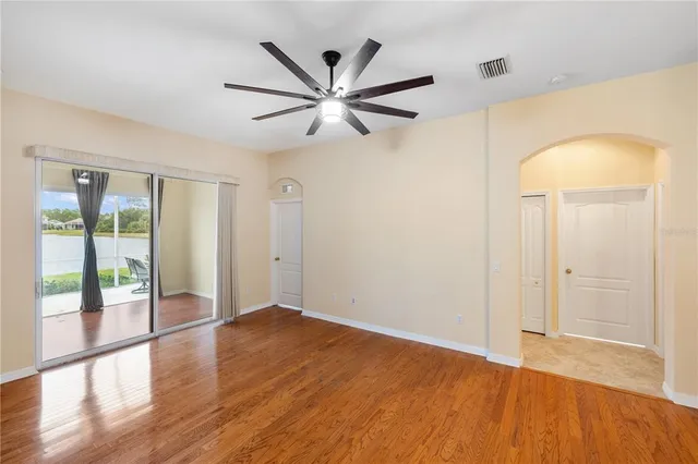 wooden floor in an empty room with a window