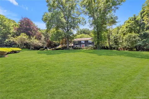 a view of a house with a yard and sitting area
