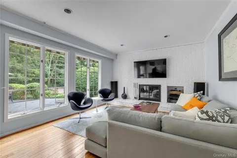 a living room with fireplace furniture and a flat screen tv
