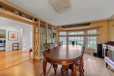 a dining room with furniture and wooden floor
