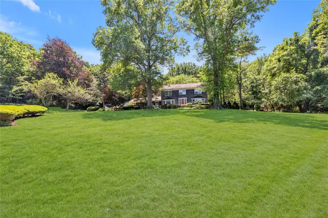 a view of a house with a yard and sitting area