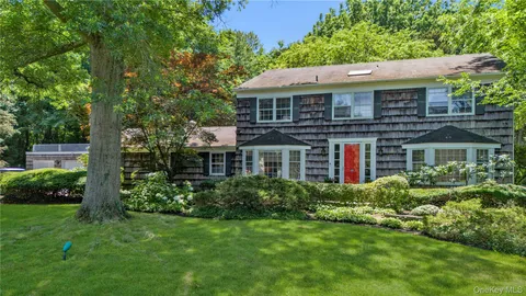 a front view of house with yard and green space