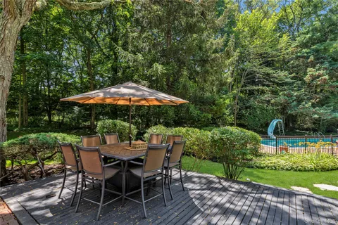 a view of backyard with seating space and green space