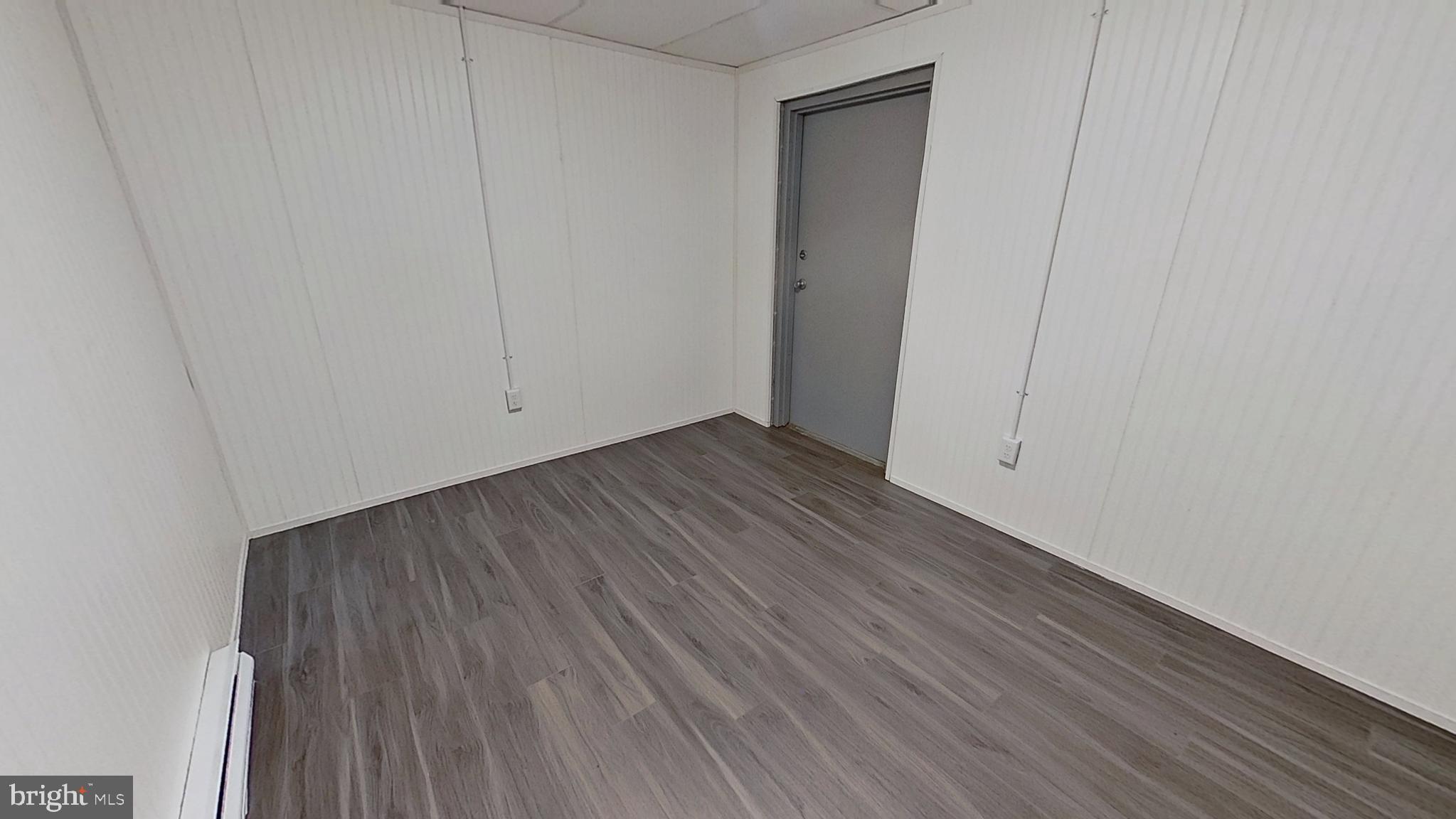 648 Broadway, Unit E Hanover, PA 17331 - Photo 6 of 12 a view of an empty room with wooden floor