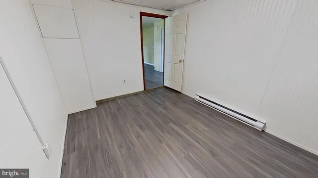 a view of a room with wooden floor