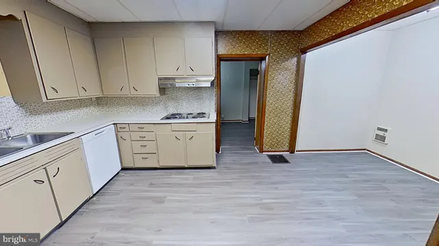 a kitchen with a sink and a refrigerator