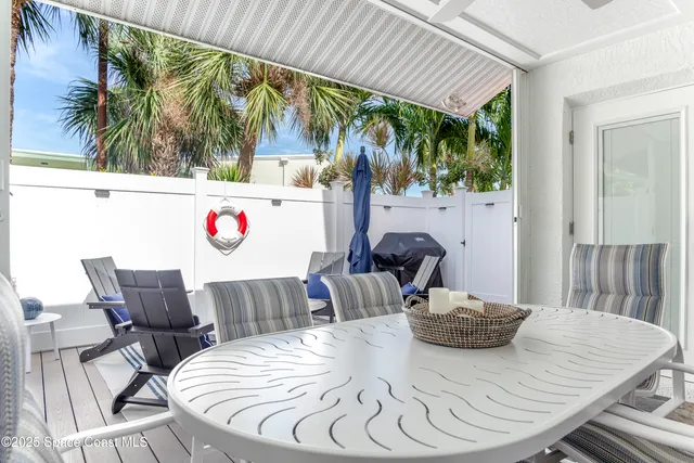 a view of table and chair with potted plants