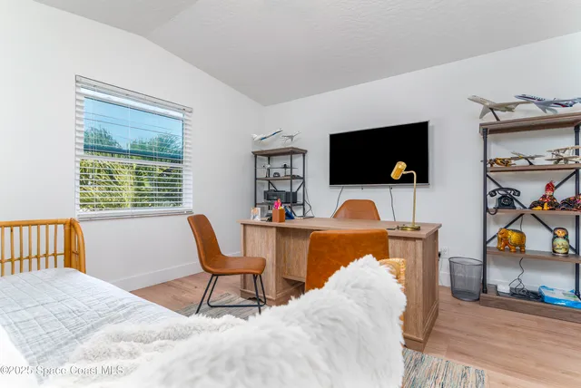 a work room with furniture and a book shelf