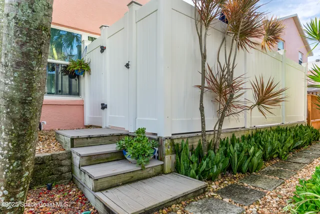 a view of a dining room with furniture a rug and wooden floor