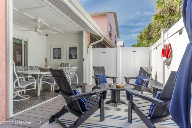 a view of a chairs and table in the balcony
