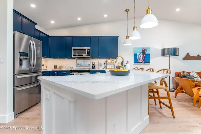 a view of kitchen with refrigerator and cabinets