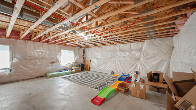 6062 Spring Street Stansbury Park, UT 84074 - Photo 25 of 36 Unfinished basement with exposed ceiling joists, concrete flooring, and multiple windows