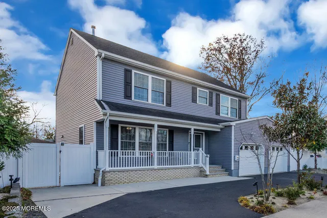 a front view of a house with a yard garage and outdoor seating