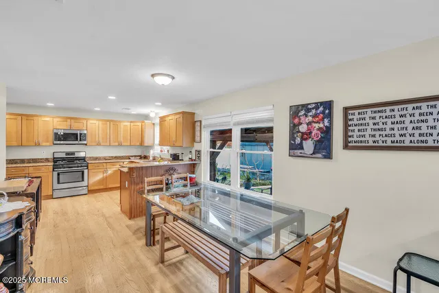 a living room with stainless steel appliances kitchen island granite countertop furniture and a kitchen view